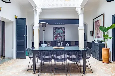a dining room with a blue table and chairs at Maison Meurisse Tlata private and Daily Breakfast in Marrakech