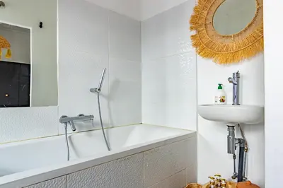 a bathroom with a bath tub and a sink at Maison Meurisse Tlata private and Daily Breakfast in Marrakech