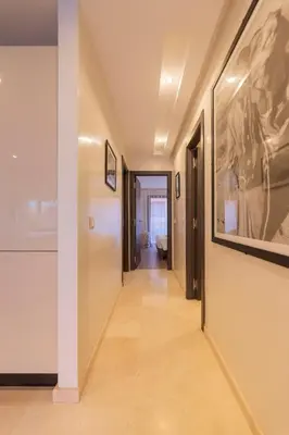 a hallway in a house with paintings on the walls at Sublime appartement 2 chambres en plein centre entre Gueliz et hivernage avec piscine in Marrakech
