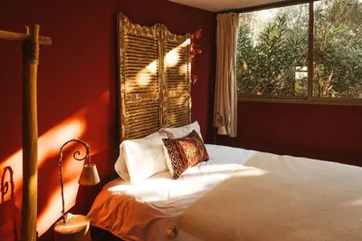 a bedroom with a bed with a pillow and a window at Oasis Garden Marrakech in Marrakech