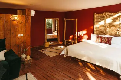 a bedroom with a white bed and a mirror at Oasis Garden Marrakech in Marrakech