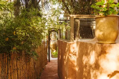 a fence with a vase on the side of it at Oasis Garden Marrakech in Marrakech