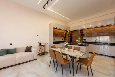 a living room with a white couch and a table and chairs at Villa Soliya 4 Rooms with private pool in Marrakech