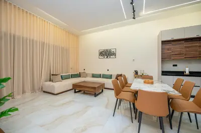 a living room with a couch and a table and chairs at Villa Soliya 4 Rooms with private pool in Marrakech