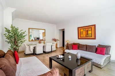 a living room with a couch and a table at Bright & Cozy Appt with Exclusive Private terrace in Marrakech