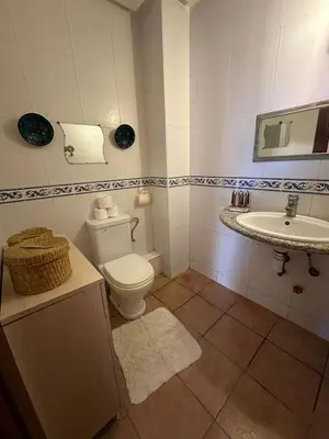a bathroom with a toilet and a sink at Appartement avec piscine Vue colline à Gueliz in Marrakech