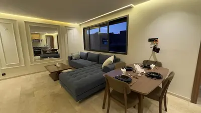 a woman taking a picture of a living room at Stylish 1-Bed Retreat in Marrakech