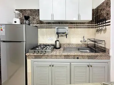 a kitchen with a refrigerator and a sink at L'Havre de Paix 2 in Marrakech