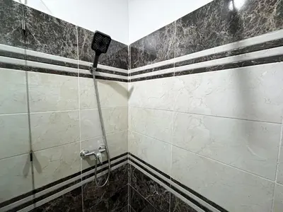 a bathroom with a shower with black and white tiles at L'Havre de Paix 2 in Marrakech