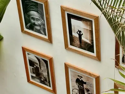 a group of framed pictures on a wall at Riad melqa piscine privée - Medina Marrakech in Marrakech