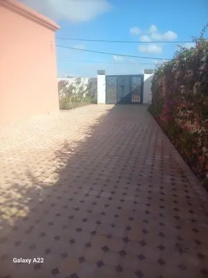 a walkway leading to a building with a gate at Villa Marrackech in Marrakech