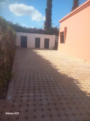 a brick driveway with a building in the background at Villa Marrackech in Marrakech
