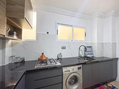 a kitchen with a sink and a washing machine at Urban Cocoon Quiet and modern in Marrakech