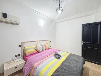 a bedroom with a bed with a backpack on it at Urban Cocoon Quiet and modern in Marrakech