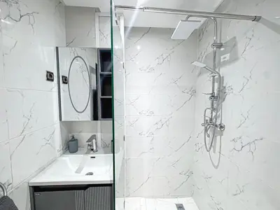 a bathroom with a shower and a sink at Urban Cocoon Quiet and modern in Marrakech