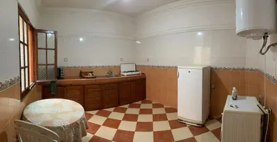 a kitchen with a checkered floor and a refrigerator at Appartement proche de l'airoport in Marrakech