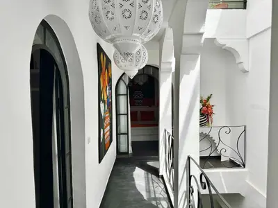 a hallway with a chandelier in a building at Riad Florival breakfast private kasbah in Marrakech