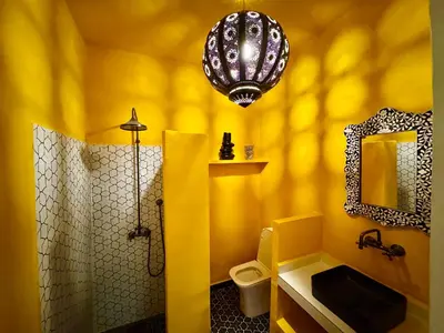 a yellow bathroom with a toilet and a mirror at Riad Florival breakfast private kasbah in Marrakech