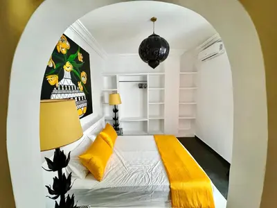 a room with a bed with yellow pillows at Riad Florival breakfast private kasbah in Marrakech