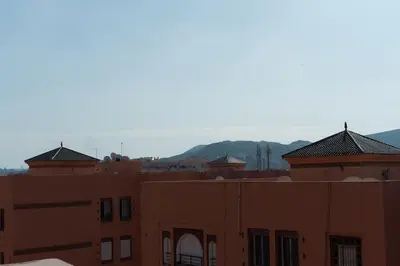a group of buildings with mountains in the background at Maison M, Spacious 2-Bedroom Apartment in Marrakech in Marrakech