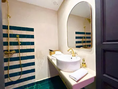 a bathroom with a sink and a mirror at Maison Meurisse KHAMSaPrivate pool and breakfast in Marrakech