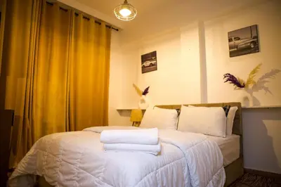 a bedroom with a bed with towels on it at Le Loft Chic Hivernage Piscine & Parking Privé in Marrakech
