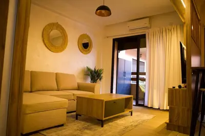 a living room with a couch and a coffee table at Le Loft Chic Hivernage Piscine & Parking Privé in Marrakech