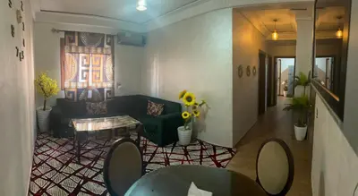 a living room with a couch and a table at Appt á louer TF2 in Marrakech