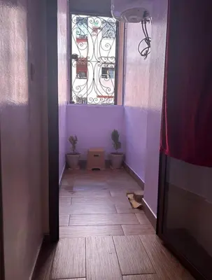 a hallway with a window and a floor with plants at Appt á louer TF2 in Marrakech