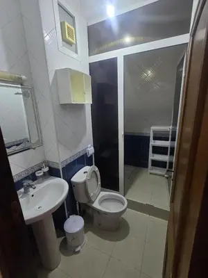 a bathroom with a toilet and a sink and a shower at Beautiful comfortable apartment in a secure residence in Marrakech