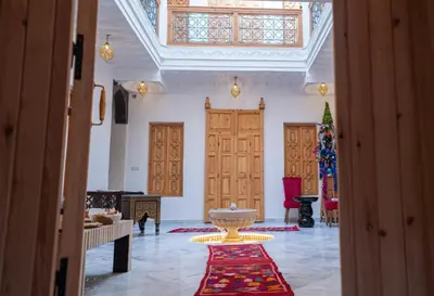 a large room with a large vase on a rug at Riad Dreams Med in Marrakech