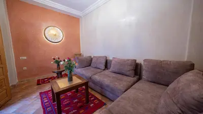 a living room with a couch and a table at Riad Dreams Med in Marrakech