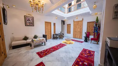 a living room with a couch and a table at Riad Dreams Med in Marrakech