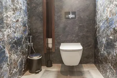 a bathroom with a toilet and a trash can at Villa Sunstone Marrakech in Marrakech