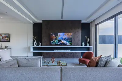 a living room with a couch and a tv at Villa Sunstone Marrakech in Marrakech