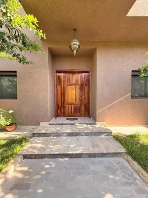 a front door of a house with a door at Vibrant Modern House, 20 Min from Gueliz & Airport in Marrakech