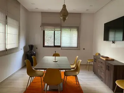 a dining room with a table and chairs at Vibrant Modern House, 20 Min from Gueliz & Airport in Marrakech