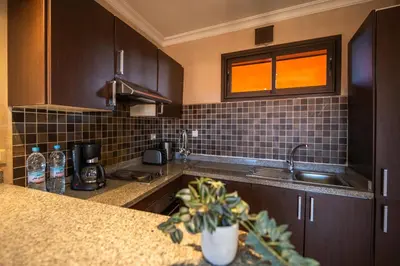 a kitchen with a sink and a counter top at River Palm, bel appartement 2 ch Piscine résidence in Marrakech