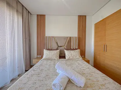 a bedroom with a large bed with two towels on it at Prestigia Argan 2Ch Piscine et Parking 6pax in Marrakech