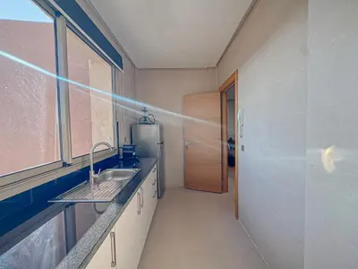 a kitchen with a sink and a refrigerator at Prestigia Argan 2Ch Piscine et Parking 6pax in Marrakech