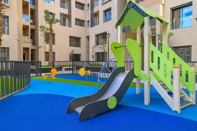 a playground at a apartment complex with a slide at Syra House Residence Moderne 2 Piscine Jacuzzi Parking in Marrakech