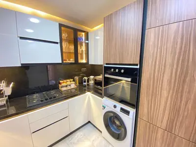 a kitchen with a washing machine and a washer at Hermès home in Marrakech