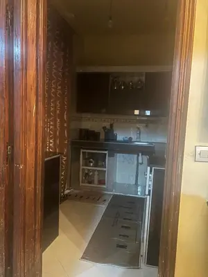 a kitchen with a stove and an open door at Espacieuse in Marrakech
