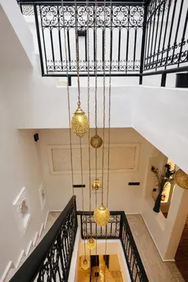 a chandelier hangs from the ceiling of a staircase at Riad chic Suite élégante au coeur de Marrakech in Marrakech