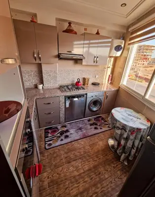 a small kitchen with a stove and a table at Cozy apartment, traditional style, mountain view in Marrakech