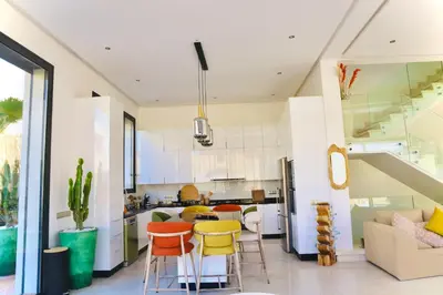 a kitchen with orange and yellow stools in a room at Luxury Villa Hedi in Marrakech