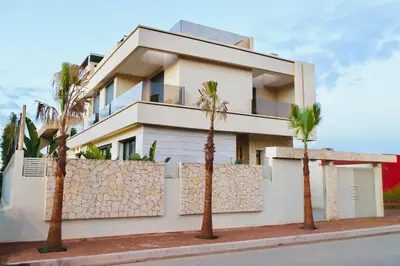 a house with palm trees in front of it at Luxury Villa Hedi in Marrakech