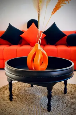 an orange vase on a table in front of a couch at Luxury Villa Hedi in Marrakech