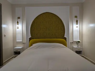 a bedroom with a large bed with a yellow headboard at Majorelle blue SPA retreat in Marrakech
