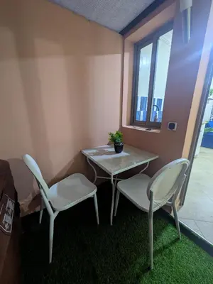a table and chairs in a room with a window at Majorelle blue SPA retreat in Marrakech